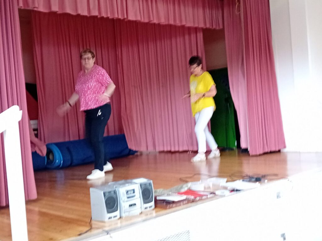 Two group members demonstrating a dance