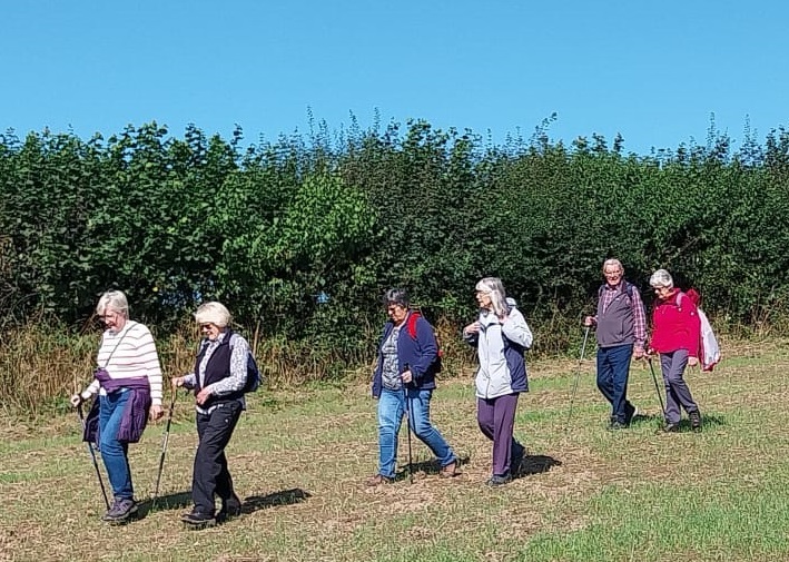 walking group members walking in the countryside